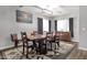 Traditional dining room with a wooden table, seating for eight, and modern lighting fixture on luxury vinyl plank flooring at 25409 N 40Th Ln, Phoenix, AZ 85083