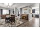 Open-concept dining room with luxury vinyl plank flooring, view of the kitchen, piano, and living room at 25409 N 40Th Ln, Phoenix, AZ 85083