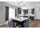 A spacious kitchen with an island, bar stool seating, sleek countertops, and modern lighting at 25409 N 40Th Ln, Phoenix, AZ 85083
