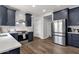 A modern kitchen featuring stainless steel appliances, white subway tile backsplash, and gray cabinets at 25409 N 40Th Ln, Phoenix, AZ 85083