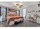 Inviting main bedroom features a ceiling fan, large bed, and access to ensuite bathroom at 25409 N 40Th Ln, Phoenix, AZ 85083