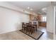 Cozy dining area with a wooden table set next to the kitchen with natural wood cabinets at 295 N Rural Rd # 143, Chandler, AZ 85226