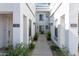 Exterior view of a well-maintained apartment complex with easy-access walkways and colorful landscaping at 295 N Rural Rd # 143, Chandler, AZ 85226