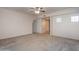 Bright, carpeted living room with neutral walls, multiple doorways, and natural light; perfect for comfortable living at 295 N Rural Rd # 143, Chandler, AZ 85226