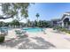 Community pool surrounded by lounge chairs and lush landscaping at 295 N Rural Rd # 143, Chandler, AZ 85226