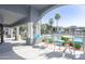 Covered patio area overlooking the community swimming pool with lounge seating at 295 N Rural Rd # 143, Chandler, AZ 85226