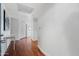 Hallway with warm hardwood floors, white walls, and access to multiple rooms at 310 S 4Th St # 601, Phoenix, AZ 85004