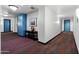 Hallway with accent-colored doors, a sleek console table, and stylish wall art at 310 S 4Th St # 601, Phoenix, AZ 85004