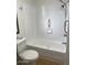 This is an all white bathroom with a toilet and a built in shower and bathtub at 3104 E Broadway Rd # 207, Mesa, AZ 85204