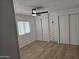 An empty bedroom with built-in cabinets, wood floors and light streaming from the window at 3104 E Broadway Rd # 207, Mesa, AZ 85204