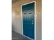 This is a close up of the blue door to the home with the door knob and the light switch at 3104 E Broadway Rd # 207, Mesa, AZ 85204