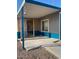 This home has blue and beige siding, a concrete porch and a gravel yard at 3104 E Broadway Rd # 207, Mesa, AZ 85204