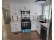 Updated kitchen with stainless steel appliances and white cabinets, illuminated by natural light at 3104 E Broadway Rd # 207, Mesa, AZ 85204