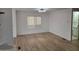 Bright living room with wood-look flooring and a large window for plenty of natural light at 3104 E Broadway Rd # 207, Mesa, AZ 85204