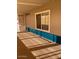 Large porch with blue siding, carpet and windows that let in natural light at 3104 E Broadway Rd # 207, Mesa, AZ 85204
