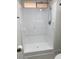All white standing shower with white grab bars, adjustable shower head and a built in shelf at 3104 E Broadway Rd # 207, Mesa, AZ 85204