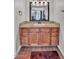 Bathroom with wood cabinets, granite counters and stylish wood look vinyl flooring at 3500 N Hayden Rd # 203, Scottsdale, AZ 85251