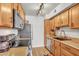 A cozy kitchen featuring tan cabinets, granite countertops, and modern stainless steel appliances at 3500 N Hayden Rd # 203, Scottsdale, AZ 85251