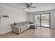 A well-lit living room featuring a ceiling fan, sliding glass doors, and comfortable sectional sofa at 3500 N Hayden Rd # 203, Scottsdale, AZ 85251