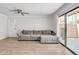 A well-lit living room featuring a comfortable sectional sofa and sliding glass doors to the outside at 3500 N Hayden Rd # 203, Scottsdale, AZ 85251