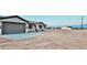 View of house with a large attached two-car garage and desert landscape at 35672 W Chipman Rd, Tonopah, AZ 85354