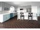 Bright kitchen features modern cabinetry, stainless appliances, tile backsplash, and a large center island at 35672 W Chipman Rd, Tonopah, AZ 85354