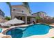 Beautiful backyard with a sparkling swimming pool, lounge chairs, and palm trees at 3692 N 292Nd Dr, Buckeye, AZ 85396