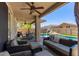 Spacious backyard with covered patio, lush lawn, and a sparkling swimming pool at 3692 N 292Nd Dr, Buckeye, AZ 85396
