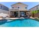 Backyard features a large swimming pool, covered patio, and beautiful landscaping at 3692 N 292Nd Dr, Buckeye, AZ 85396