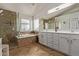 Luxurious bathroom with soaking tub, walk-in shower, and dual sinks at 3692 N 292Nd Dr, Buckeye, AZ 85396
