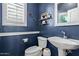 Charming powder room with stylish sink, toilet, and window bringing in natural light at 3692 N 292Nd Dr, Buckeye, AZ 85396