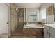 Beautiful bathroom with soaking tub, separate shower, and tiled accents at 3692 N 292Nd Dr, Buckeye, AZ 85396