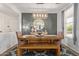 Dining room showcasing a wooden table with bench seating, modern light fixture, and stylish decor at 3692 N 292Nd Dr, Buckeye, AZ 85396