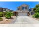 Two-story home featuring a two car garage, desert landscaping and a spacious driveway at 3692 N 292Nd Dr, Buckeye, AZ 85396