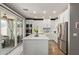 Well-lit kitchen featuring an island, stainless appliances, and access to the outdoor patio at 3692 N 292Nd Dr, Buckeye, AZ 85396