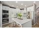 Contemporary kitchen with white cabinets, stainless steel appliances, and a spacious island at 3692 N 292Nd Dr, Buckeye, AZ 85396