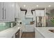 Modern kitchen with stainless steel appliances, white cabinetry, and a stylish backsplash at 3692 N 292Nd Dr, Buckeye, AZ 85396