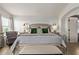 Relaxing main bedroom with ample natural light, decorative mirrors, and sitting chair at 3692 N 292Nd Dr, Buckeye, AZ 85396