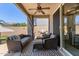 Relaxing covered patio features comfortable seating, an outdoor grill, and a ceiling fan at 3692 N 292Nd Dr, Buckeye, AZ 85396