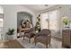 Cozy sitting area with arched entry, two armchairs, and decorative accents creating an inviting atmosphere at 3692 N 292Nd Dr, Buckeye, AZ 85396
