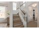 Elegant staircase with detailed treads, white railing, and natural light from nearby windows at 3692 N 292Nd Dr, Buckeye, AZ 85396