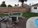 Relaxing backyard patio with wooden Adirondack chairs and lush green grass at 4020 N 44Th Pl, Phoenix, AZ 85018