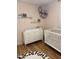 Bright Bedroom features a white crib, dresser, and charming decor at 4020 N 44Th Pl, Phoenix, AZ 85018