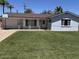 Charming home featuring a well-manicured lawn, a basketball hoop, and a welcoming porch at 4020 N 44Th Pl, Phoenix, AZ 85018