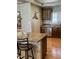 Kitchen island with bar stool seating, granite countertops, stainless steel appliances, and wooden cabinetry at 4020 N 44Th Pl, Phoenix, AZ 85018