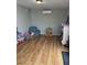 Bright playroom with laminate flooring, mini-split and storage shelf at 4020 N 44Th Pl, Phoenix, AZ 85018