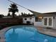 Beautiful backyard pool with sunshade, patio area, block fence and green grass at 4020 N 44Th Pl, Phoenix, AZ 85018