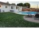 The backyard features a sparkling pool with a patio and plenty of green grass at 4020 N 44Th Pl, Phoenix, AZ 85018