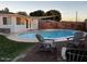 Backyard featuring swimming pool, stone patio with chairs, and lush green grass at 4020 N 44Th Pl, Phoenix, AZ 85018