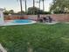 The beautiful backyard features a sparkling pool and lush green lawn at 4020 N 44Th Pl, Phoenix, AZ 85018